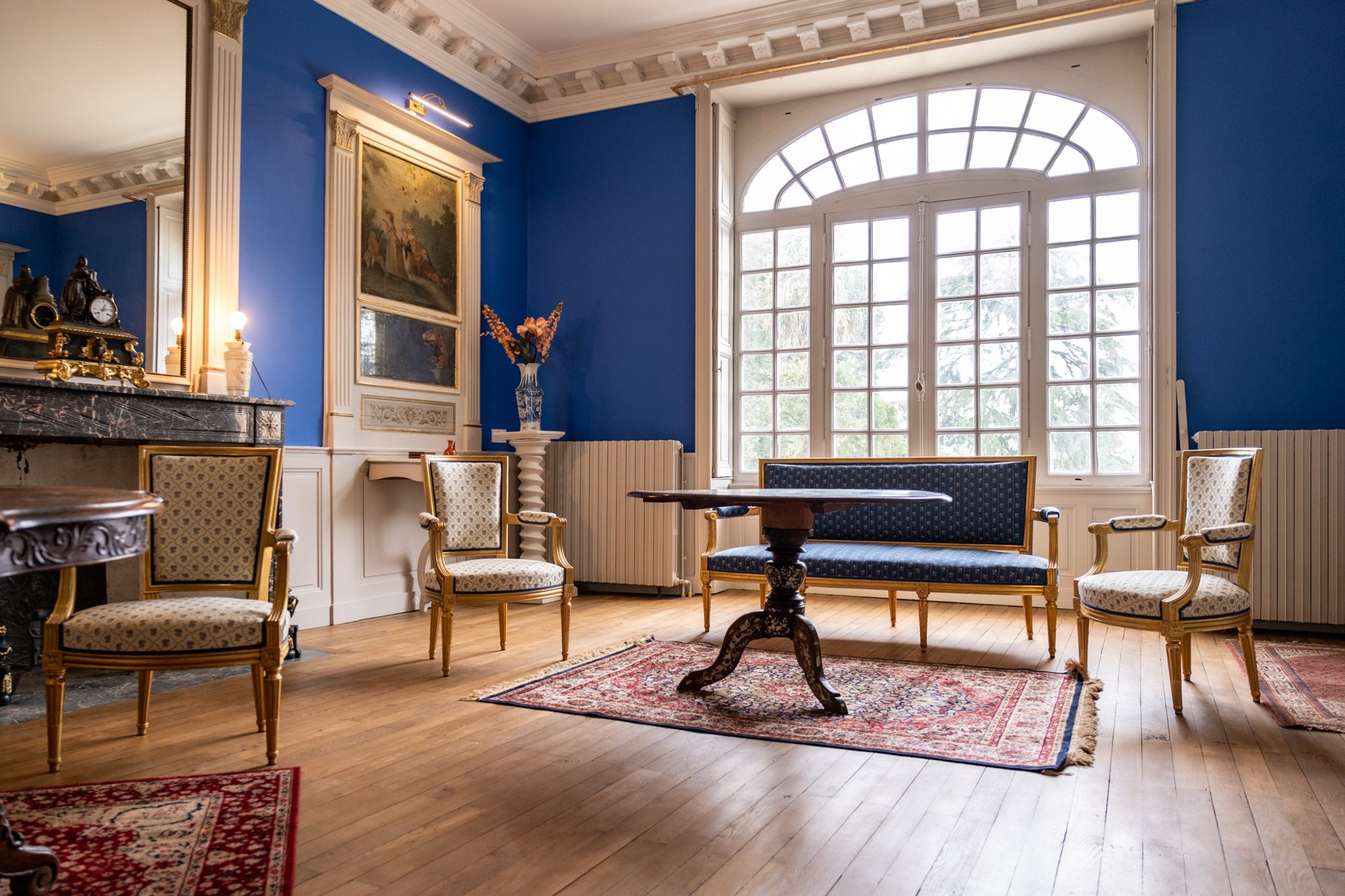 Le grand salon bleu et ses grandes fenêtres sur le parc